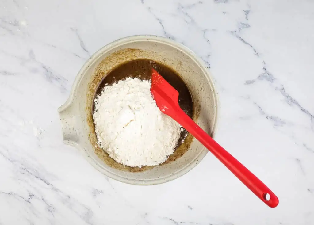 Adding flour to streusel.