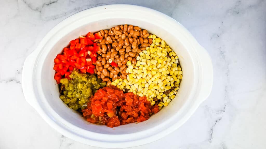 Ingredients in the bottom of a slow cooker insert.