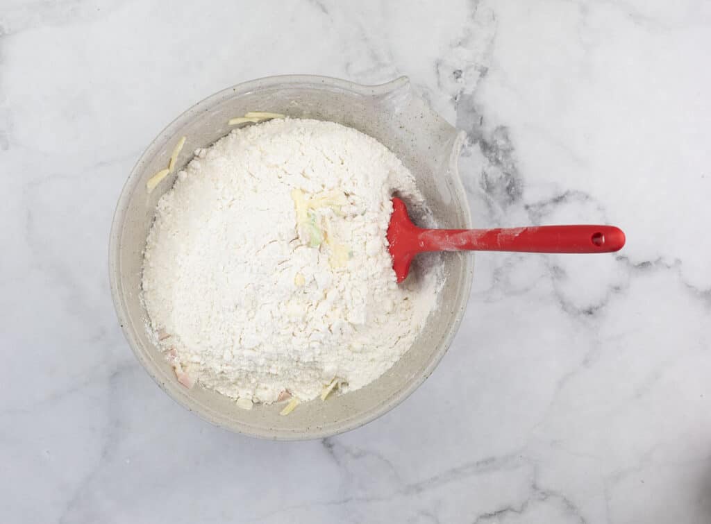 Wet and dry ingredients in a bowl about to be mixed.