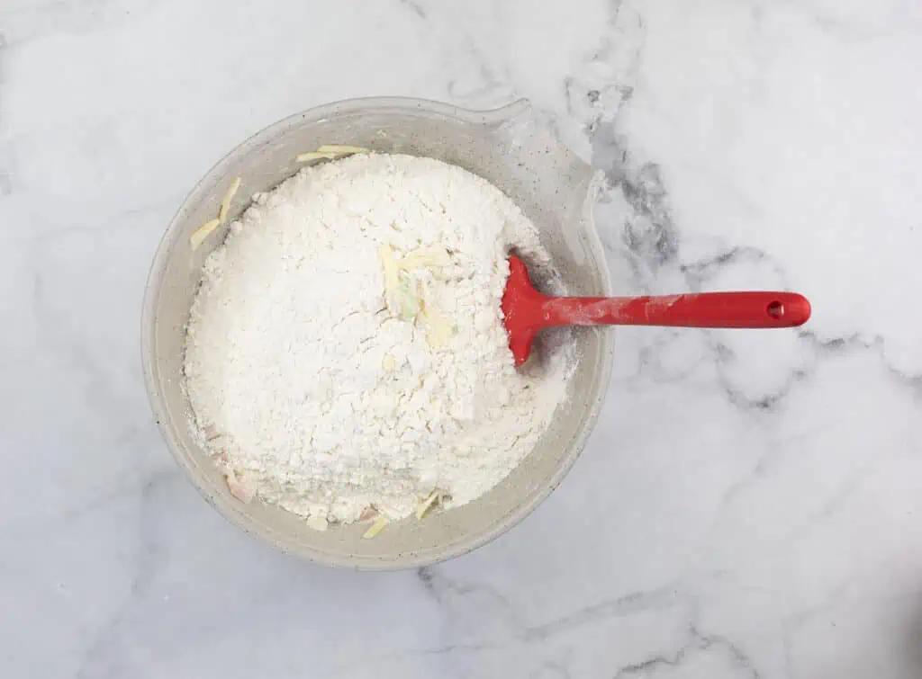 Wet and dry ingredients in a bowl about to be mixed.