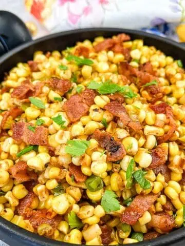 Finished Bacon-Fried Corn in a black serving bowl.