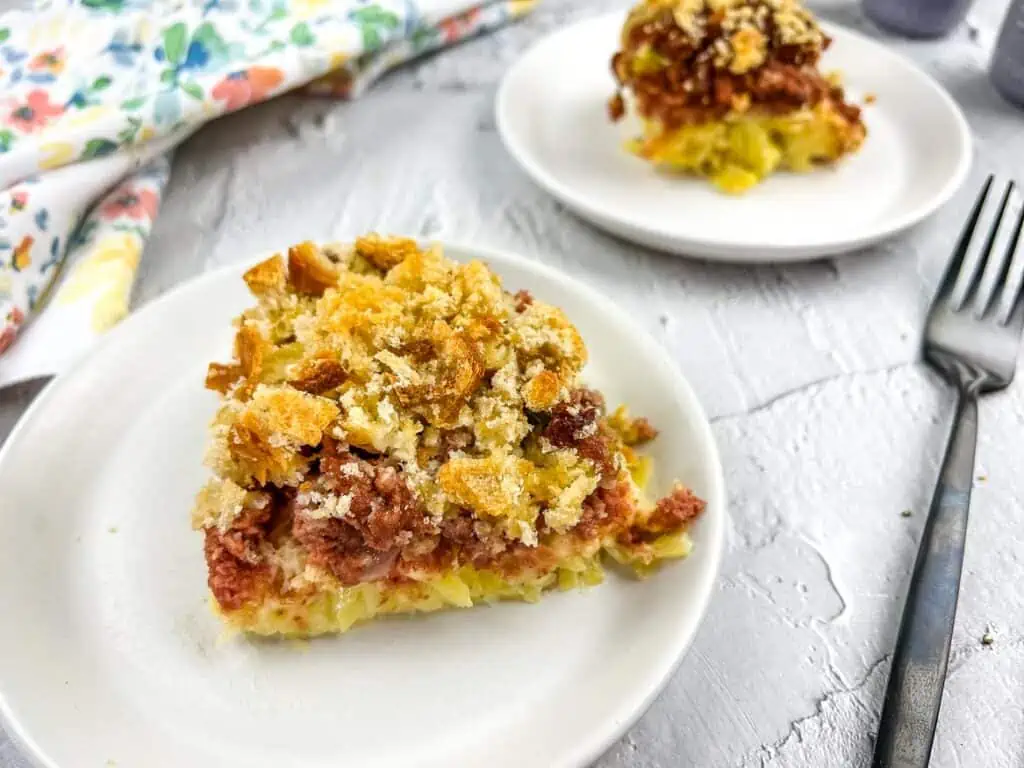 Sliced Canned Corned Beef Hash Casserole on a white plate.