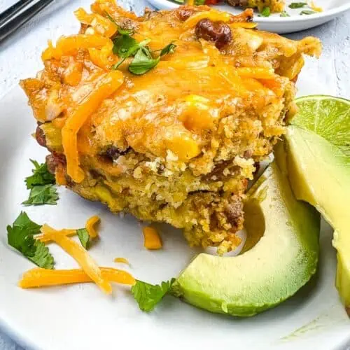 Cowboy Cornbread Casserole on a plate with avocado.