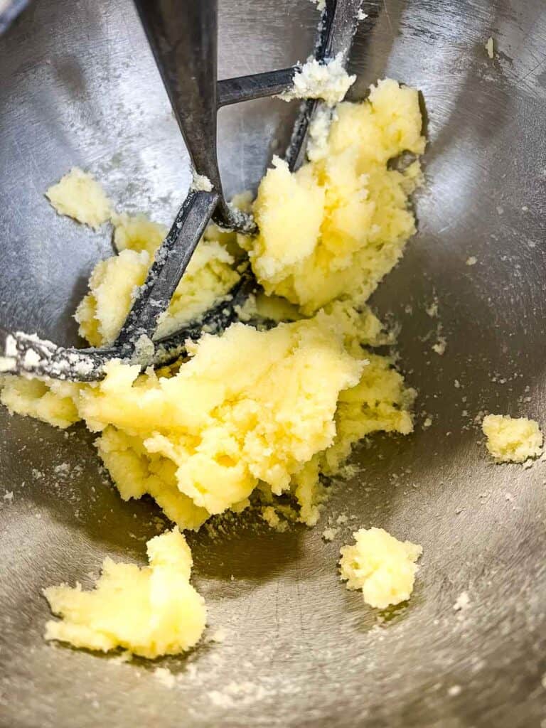 Creaming butter and sugar in the bowl of a stand mixer.