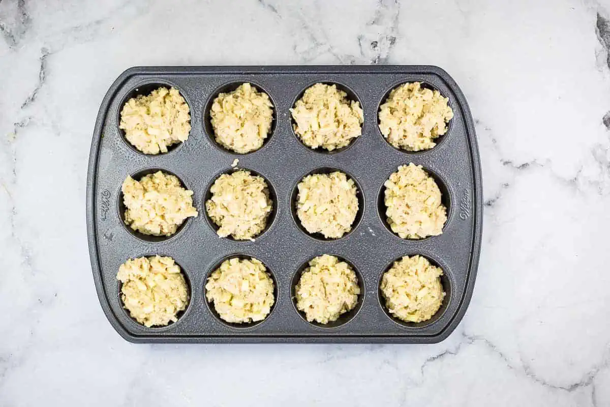 Filled muffin tin ready for baking.