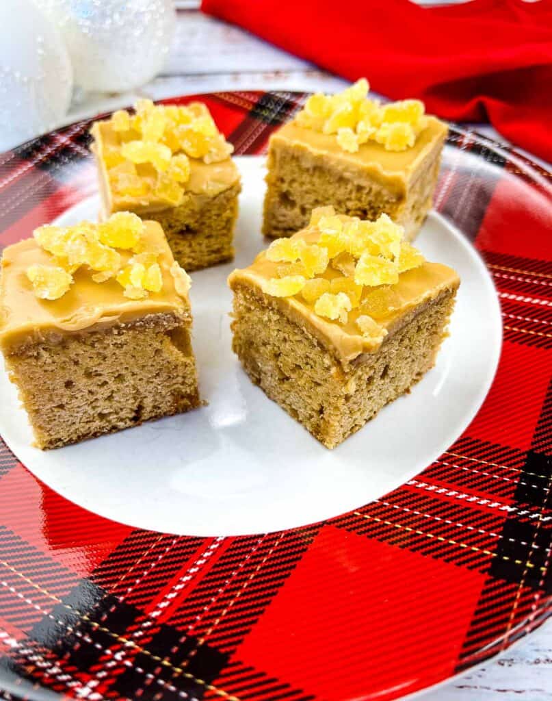 Triple Ginger Cake squares on a red and black plate.