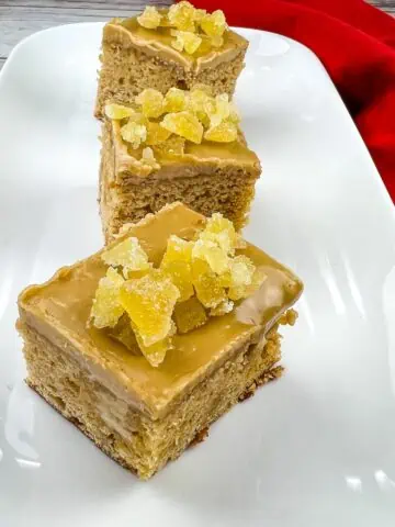 Triple Ginger Cake squares on a white platter.