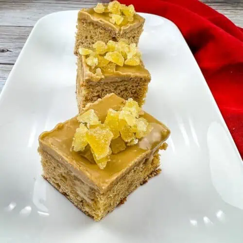 Triple Ginger Cake squares on a white platter.