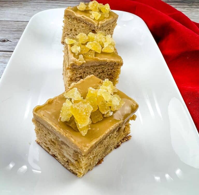 Triple Ginger Cake squares on a white platter.