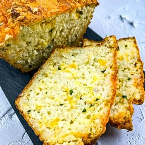 Finished Potato Cheese Bread sliced on a black platter.
