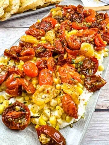 Tomato Bruschetta Board with bread in the background.