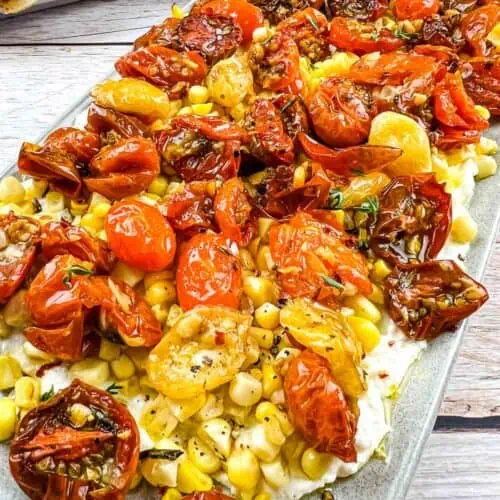 Tomato Bruschetta Board with bread in the background.
