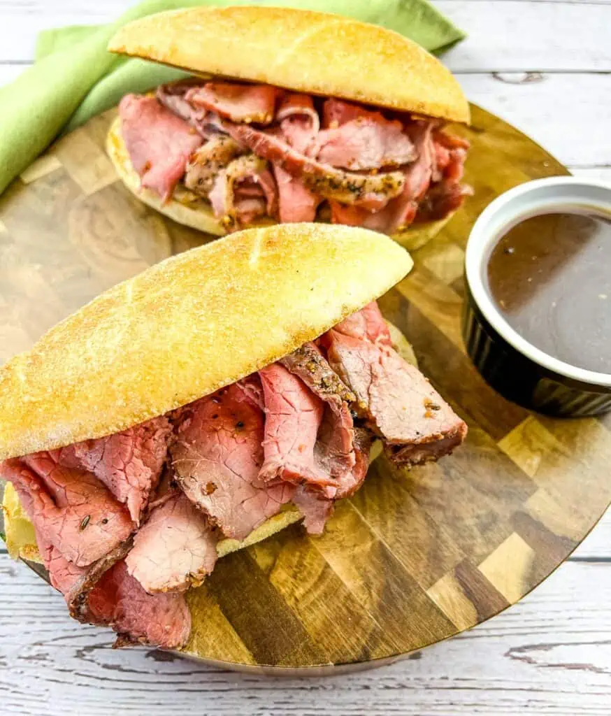 Smoked French Dip Sandwiches with jus on the side.