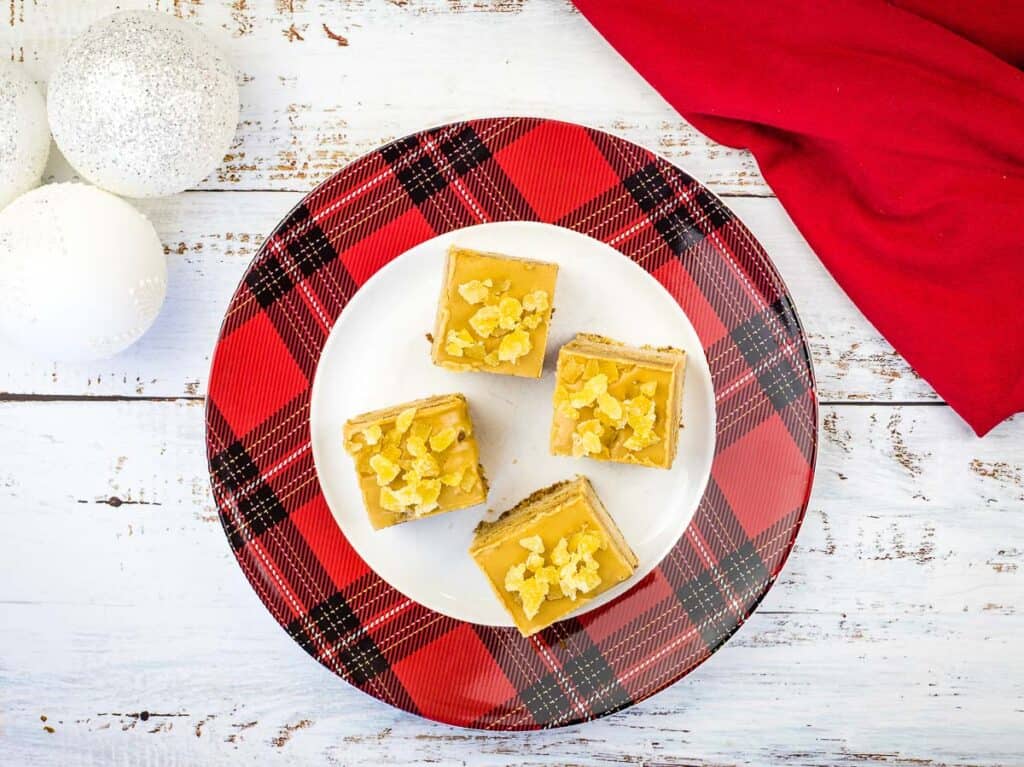 A top-down shot of 4 slices of Triple Ginger Cake on a white platter.