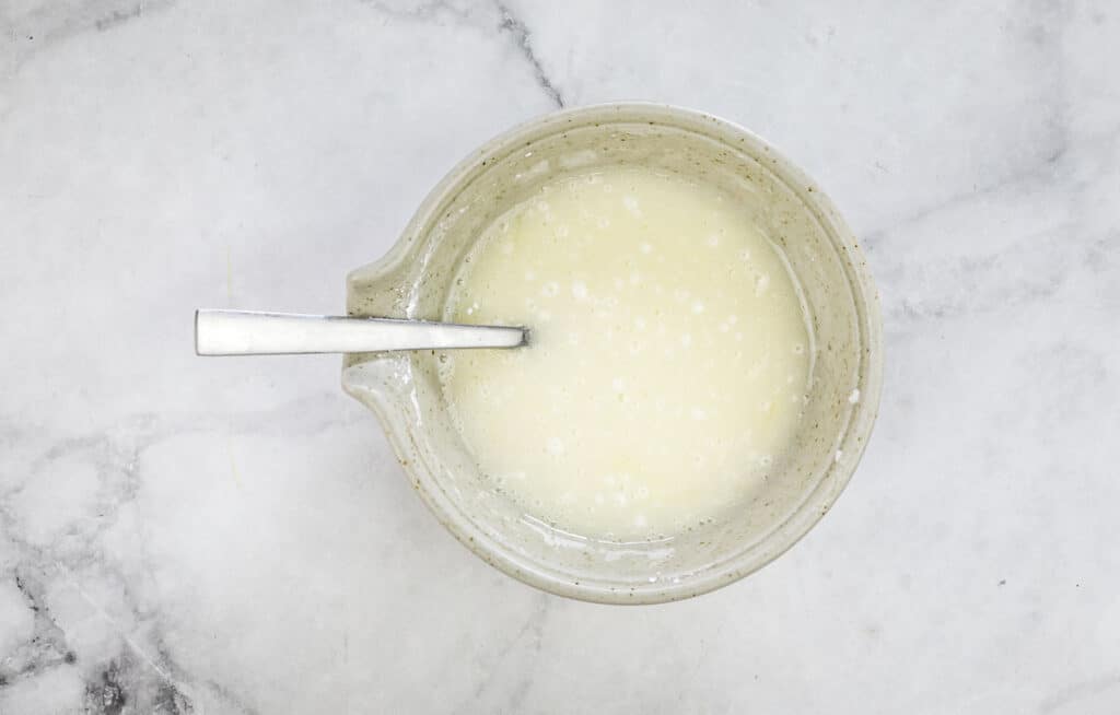 Mixed glaze in a bowl with a spoon.