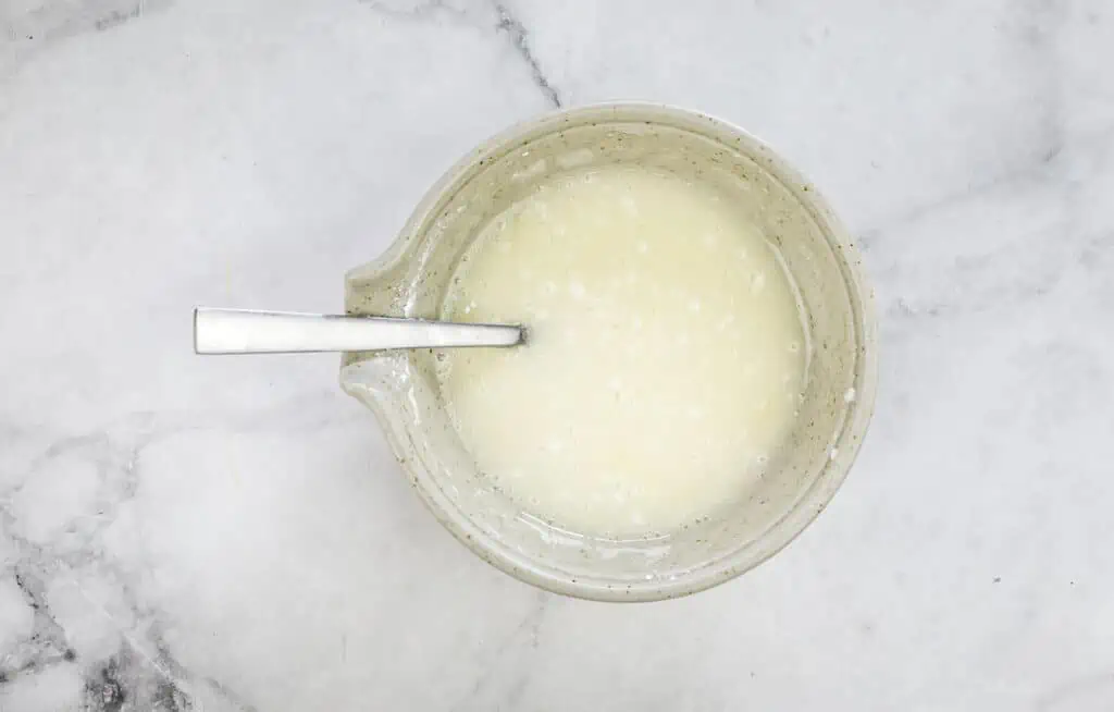 Mixed glaze in a bowl with a spoon.