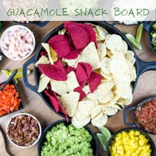 A top-down shot of a guacamole snack board.