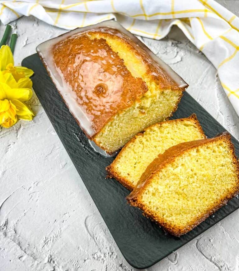 Lemon Loaf with on a black platter with a few slices.