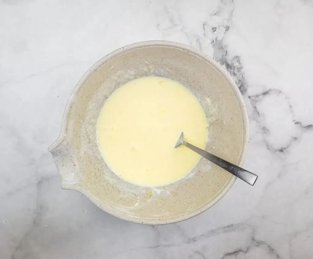 Mixing wet ingredients in a bowl.