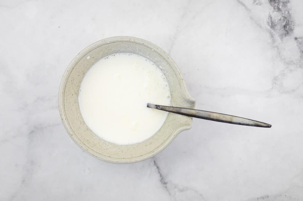 Milk and sour cream mixed in a bowl.