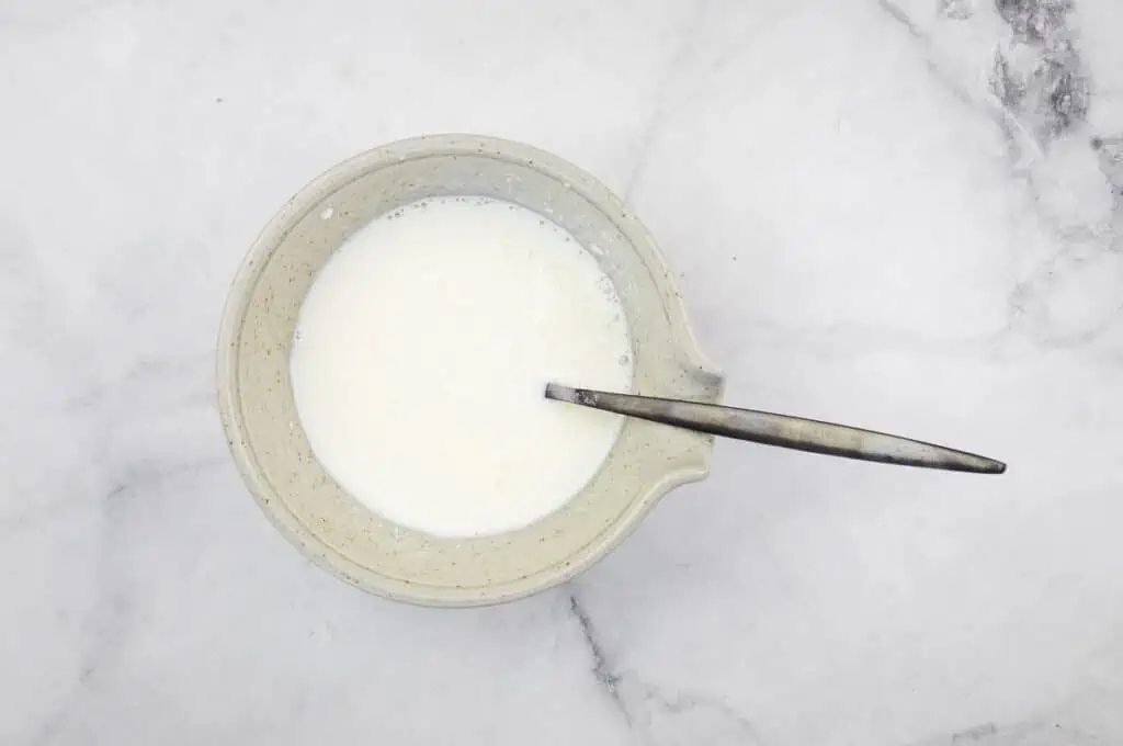 Milk and sour cream mixed in a bowl.