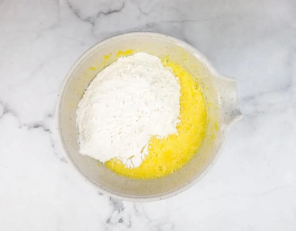 Flour added to the egg and sugar mixture.