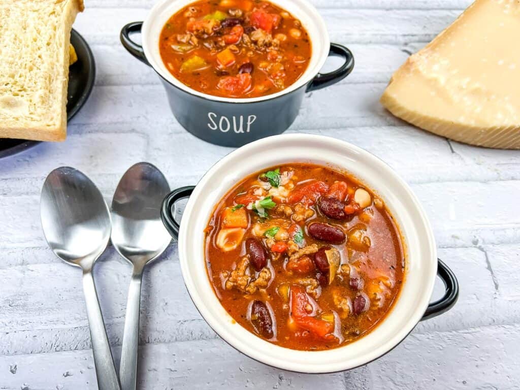 Pasta e fagioli soup with bread and cheese.
