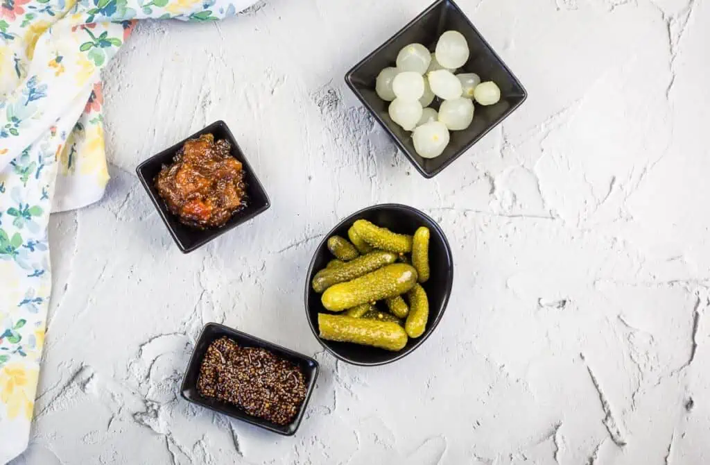 Pickles and condiments for a charcuterie board.