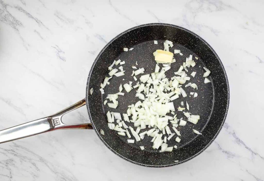 Saut&eacute;ing onions in a skillet. 