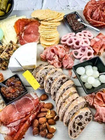 A mother's day charcuterie board with assorted meats and cheeses.