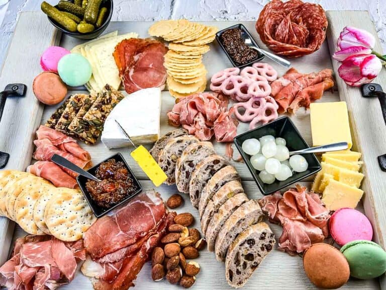 A mother's day charcuterie board with assorted meats and cheeses.