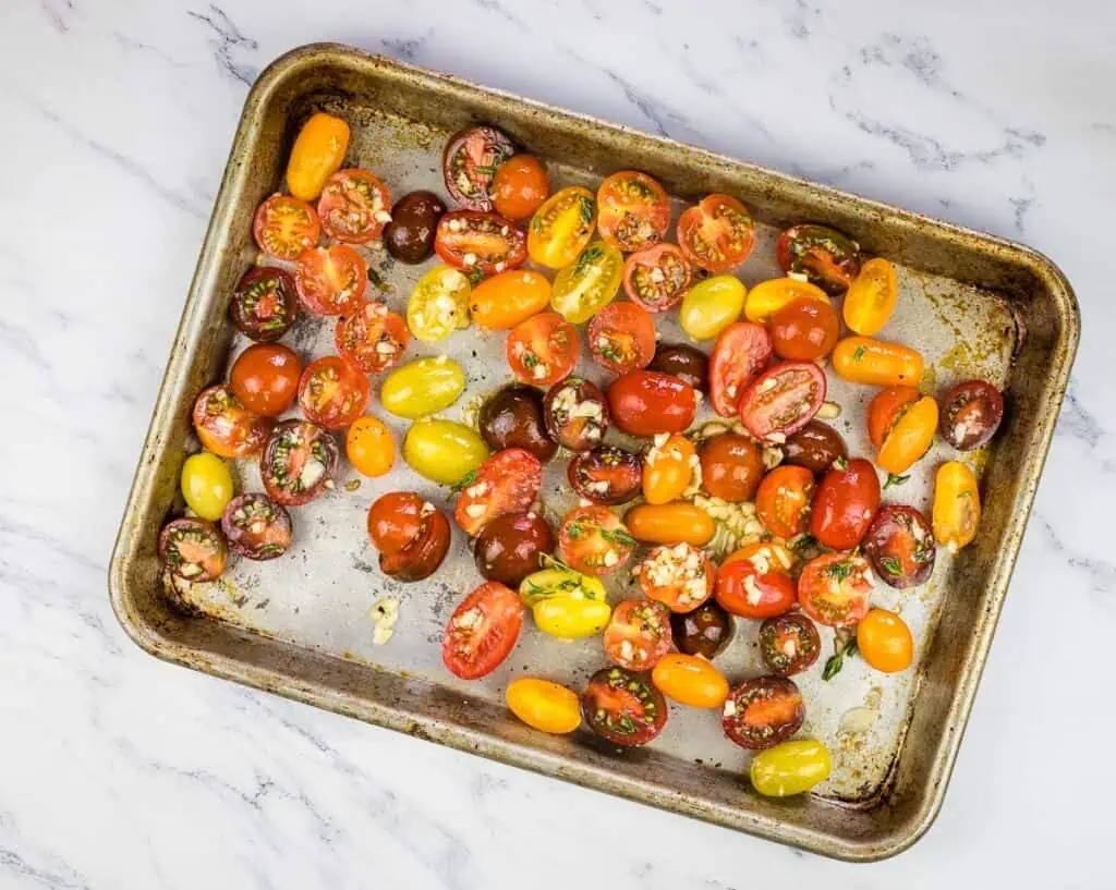 Roasting the tomatoes on a baking sheet.