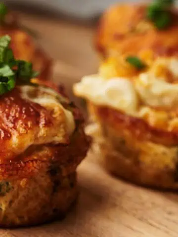 Freshly cooked egg bites on a wooden board ready to eat.