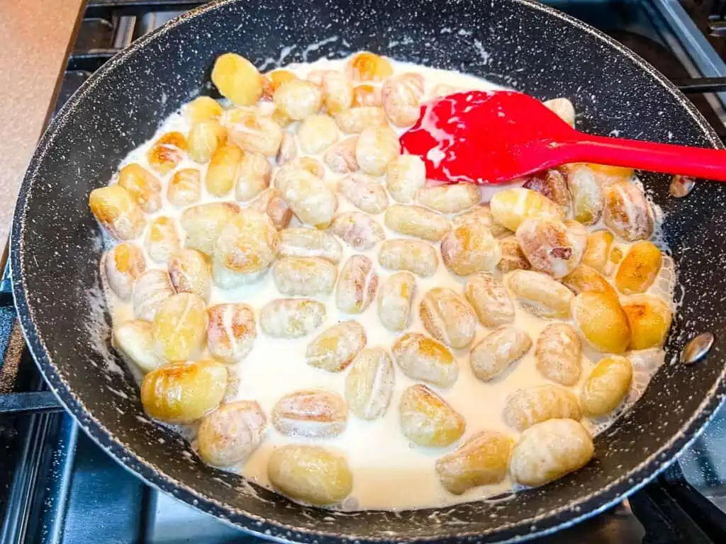 Cream and cheese added to the gnocchi.