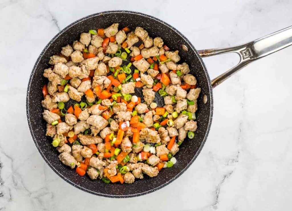 Red pepper and green onion added to skillet.