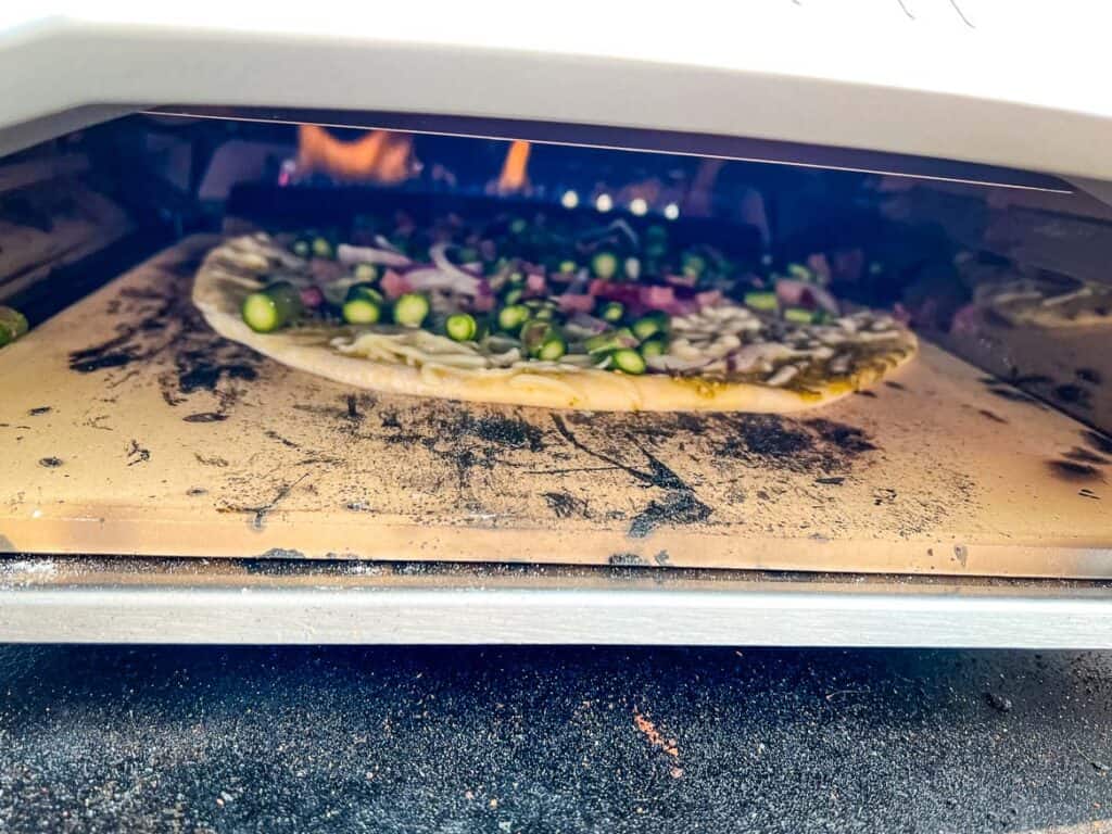 Pizza cooking in the Ooni oven.