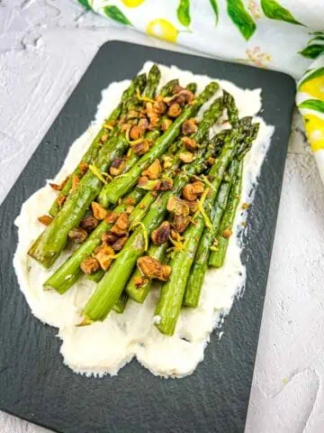 Oven Roasted Asparagus with Mascarpone on a black platter.