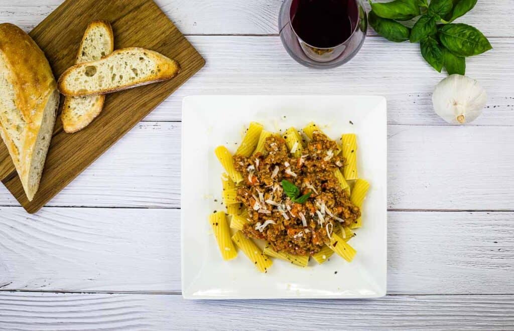 A top-down shot of Ragu Bolognese on a white plate.
