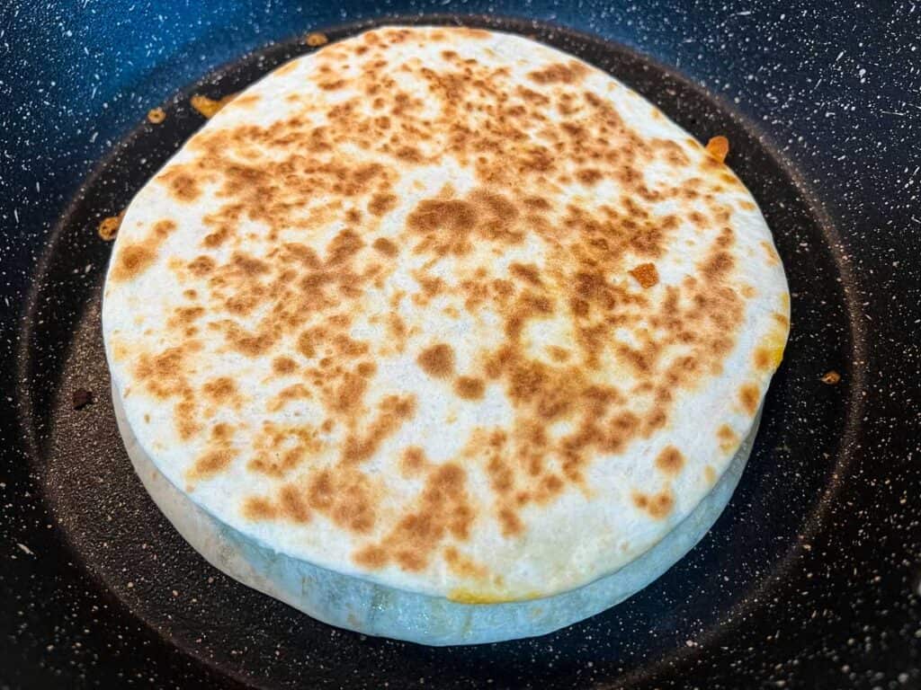 Cooked Chicken Al Pastor Quesadilla in a skillet.