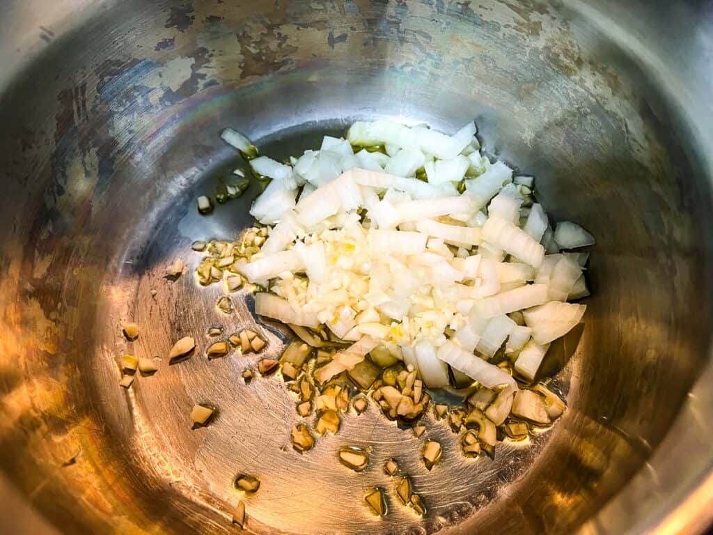 Onions and garlic in a saucepan.