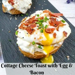 Cottage Cheese Toast with Egg and Bacon on a black platter.
