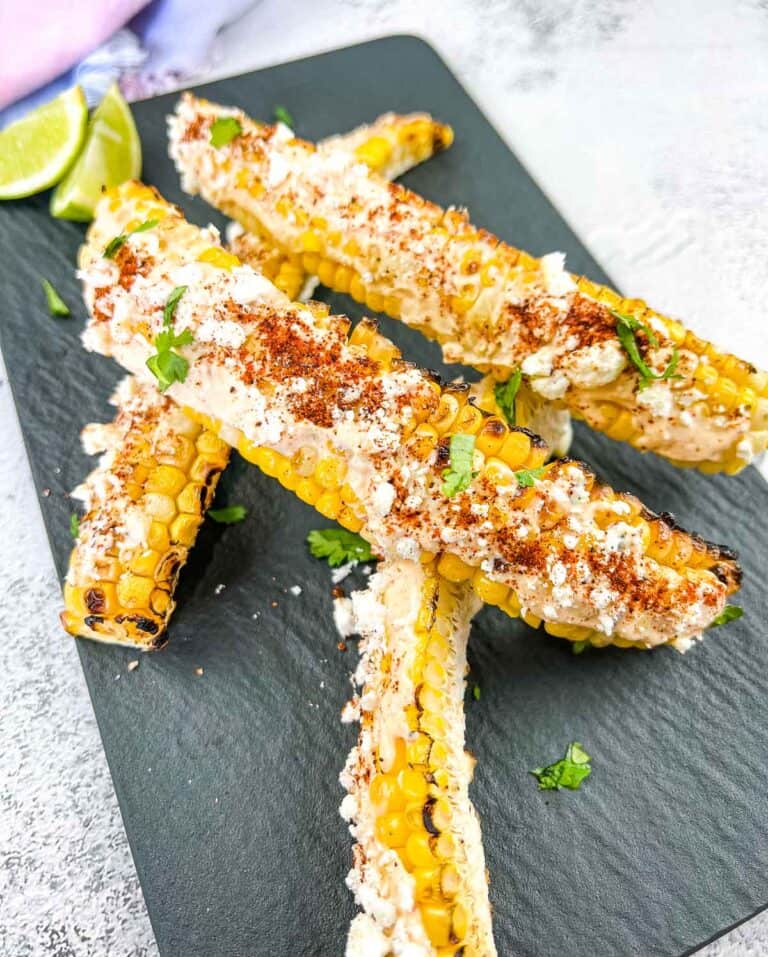 Grilled Elote Corn Ribs on a black plate.