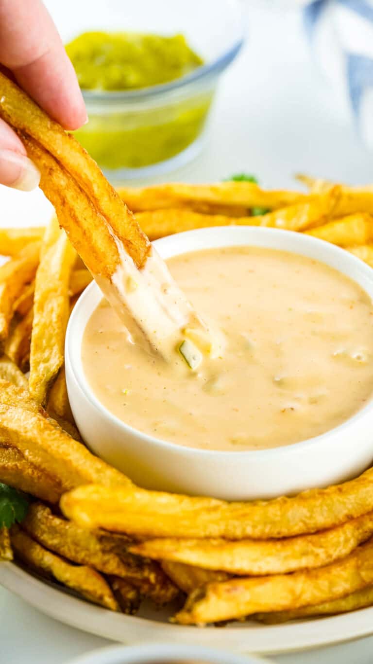 Animal Sauce in a bowl with fries around it.