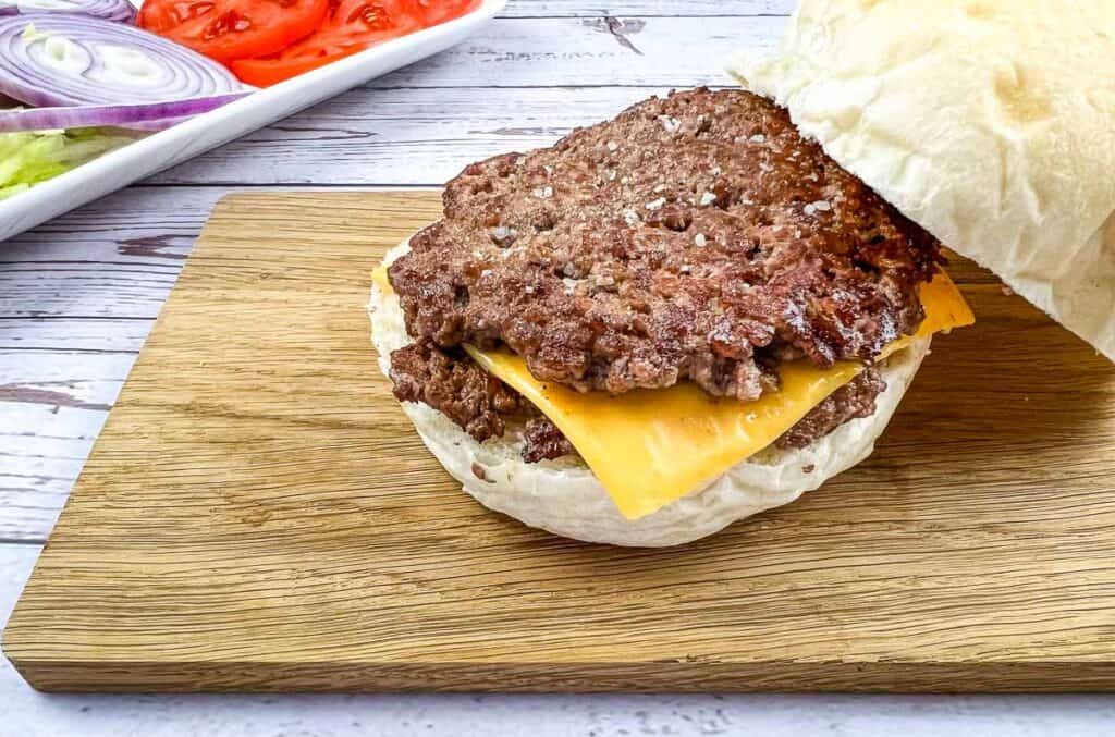 A Blackstone Griddle Smash Burger on a cutting board.