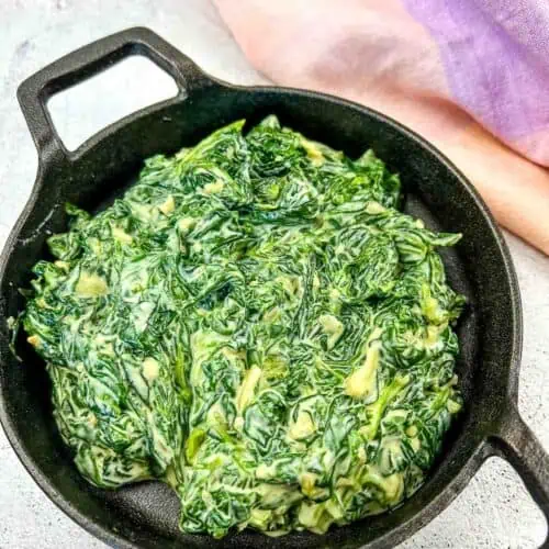 Creamed Spinach with Mascarpone in a black dish.