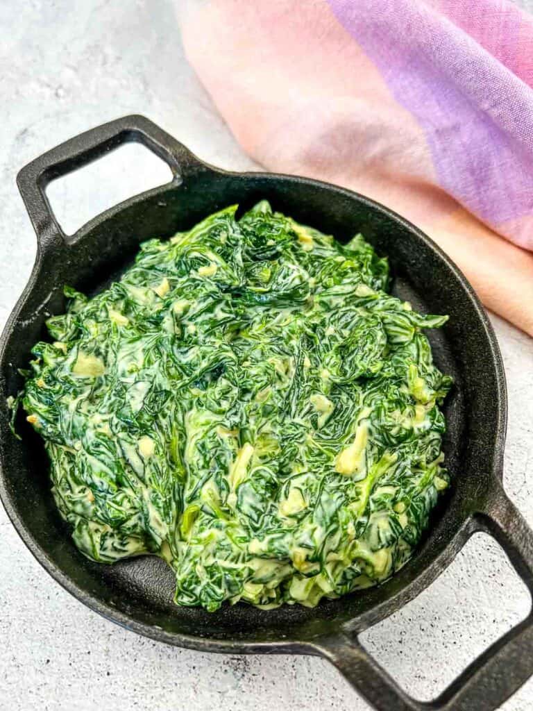 Creamed Spinach with Mascarpone in a black dish.