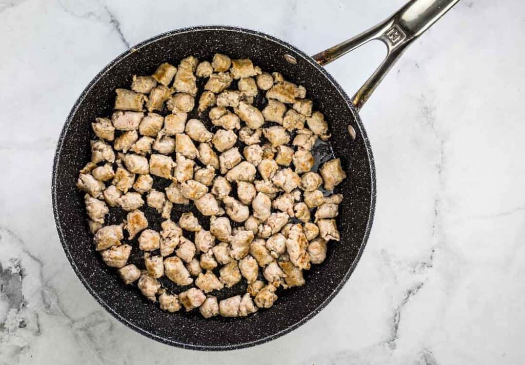 Sausage browning in a skillet.