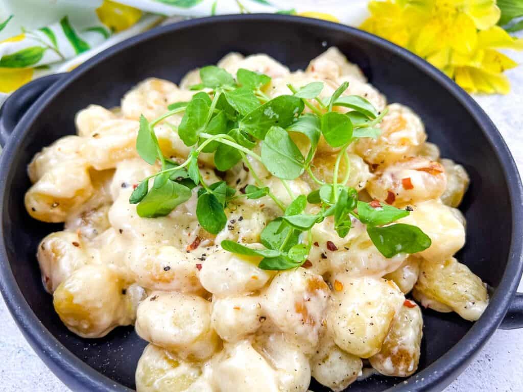 Gnocchi with Lemon Parmesan Sauce in a black serving bowl