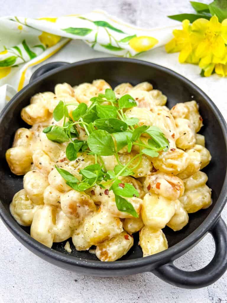 Gnocchi with Lemon Parmesan Sauce in a black serving dish.