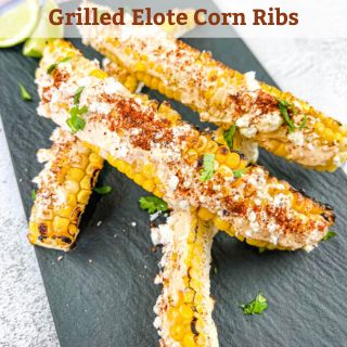 Grilled elote corn ribs on a black plate.